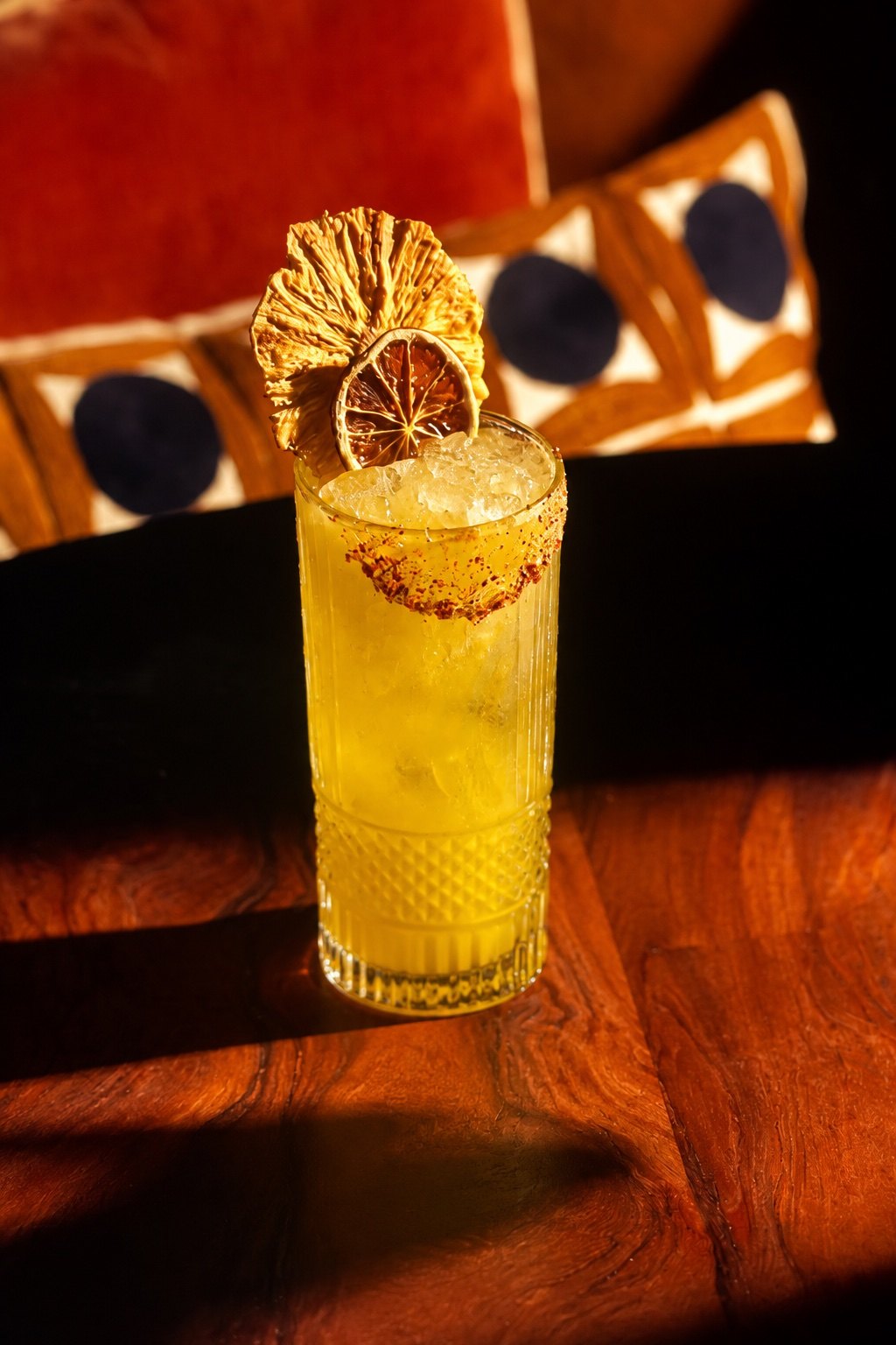 Mezcal and Mexican whiskey highball with chamoy rim and dried citrus garnish
